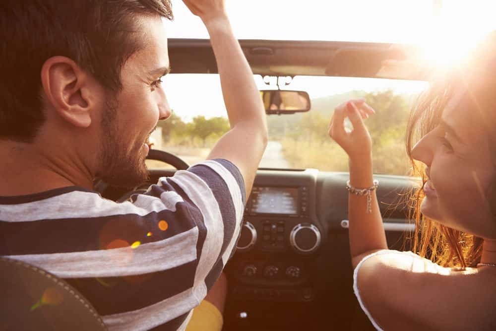 Couple On A Road Trip Using A Rental Car